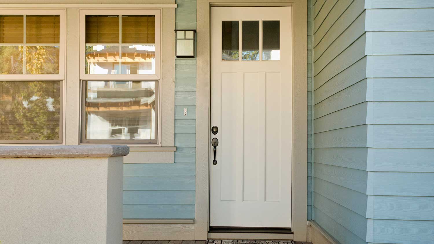 The entrance of a house with wood siding