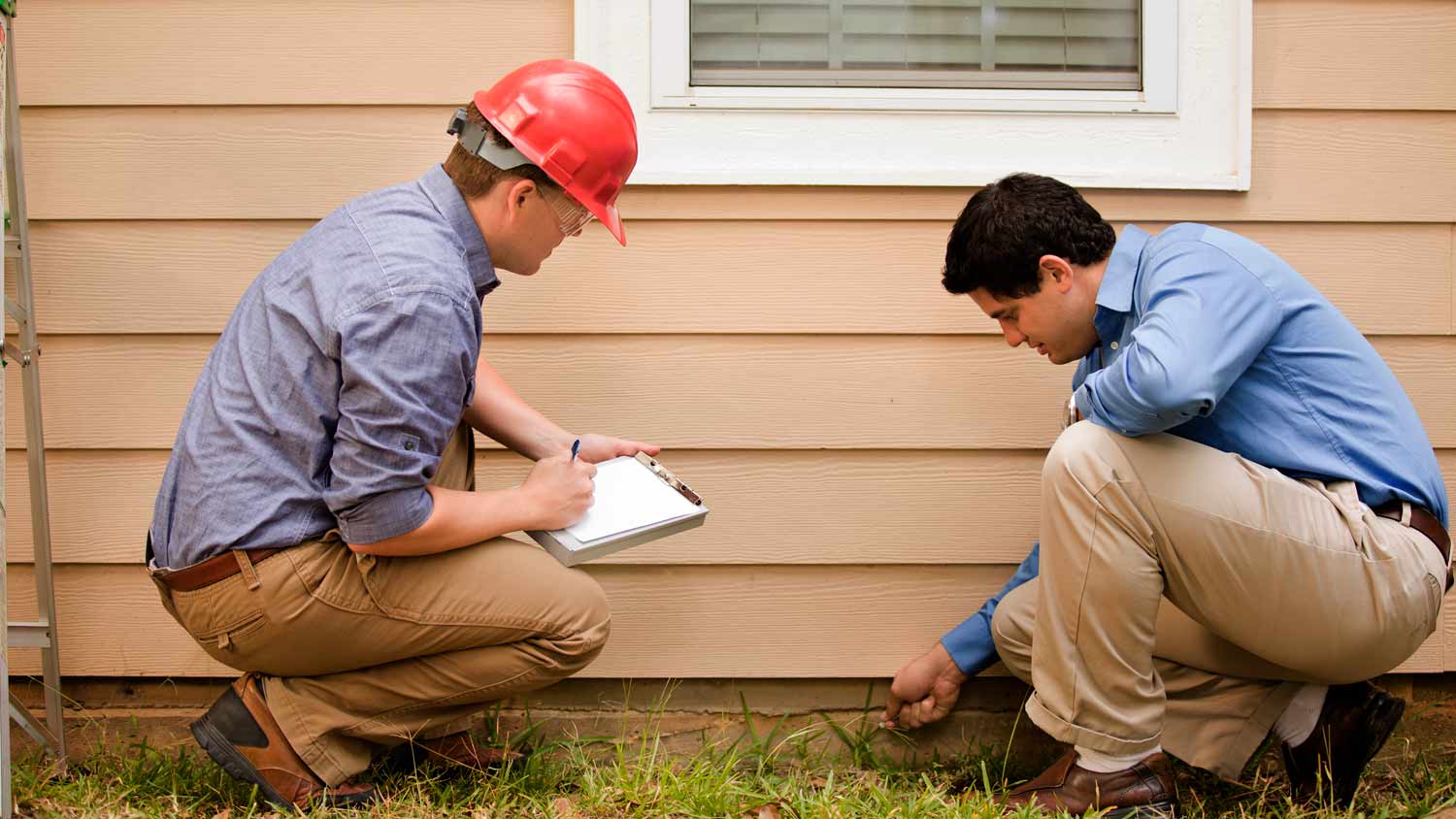 None contractor inspecting house foundation