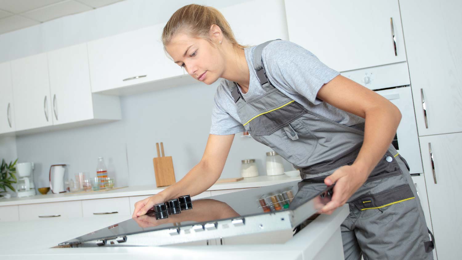 None A professional installing a ceramic glass stove top