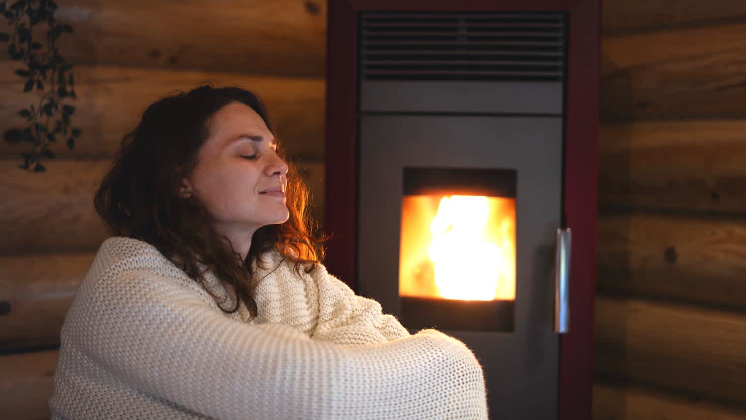 cozy woman sitting by pellet stove