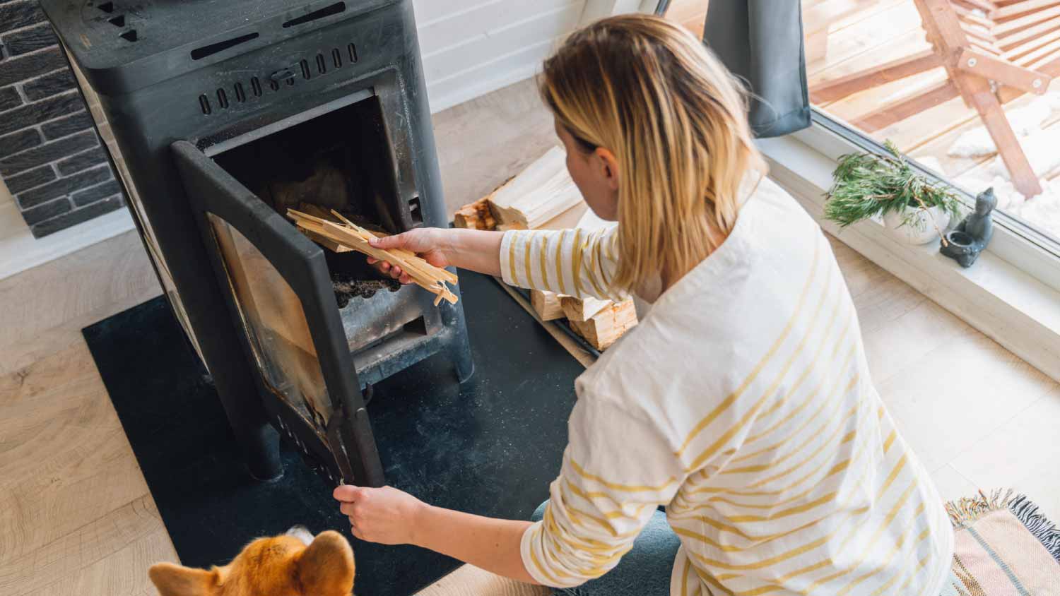 None Woman putting wood in stove