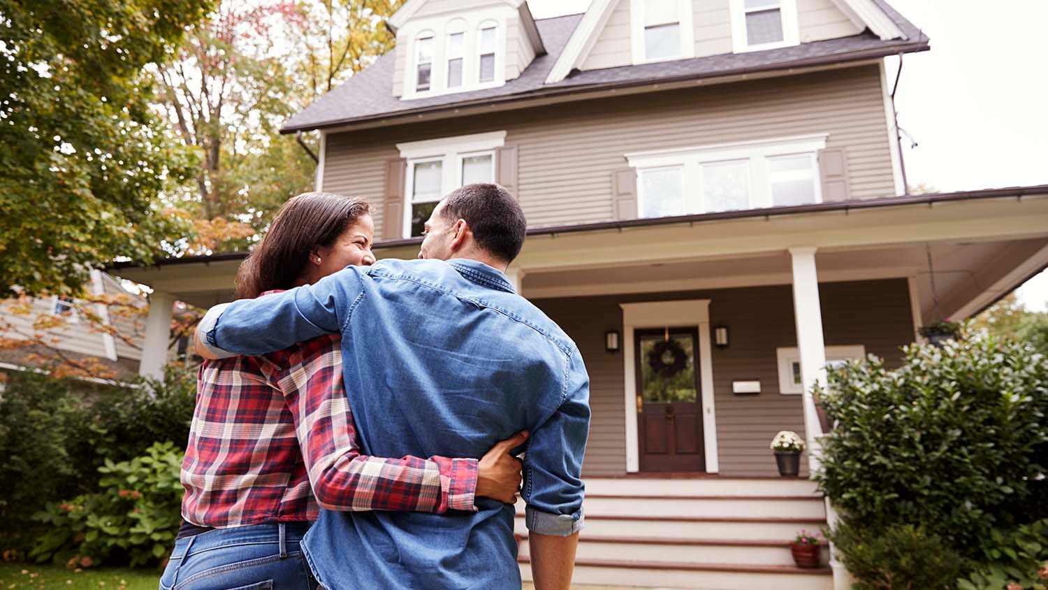 couple walking towards house