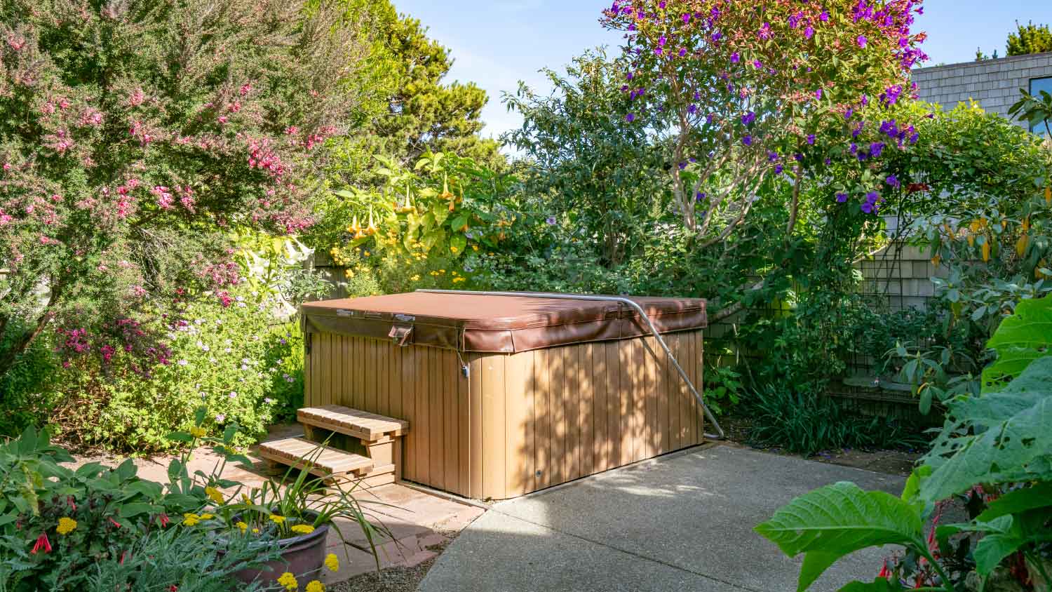 None outdoor hot tub surrounded by flowers