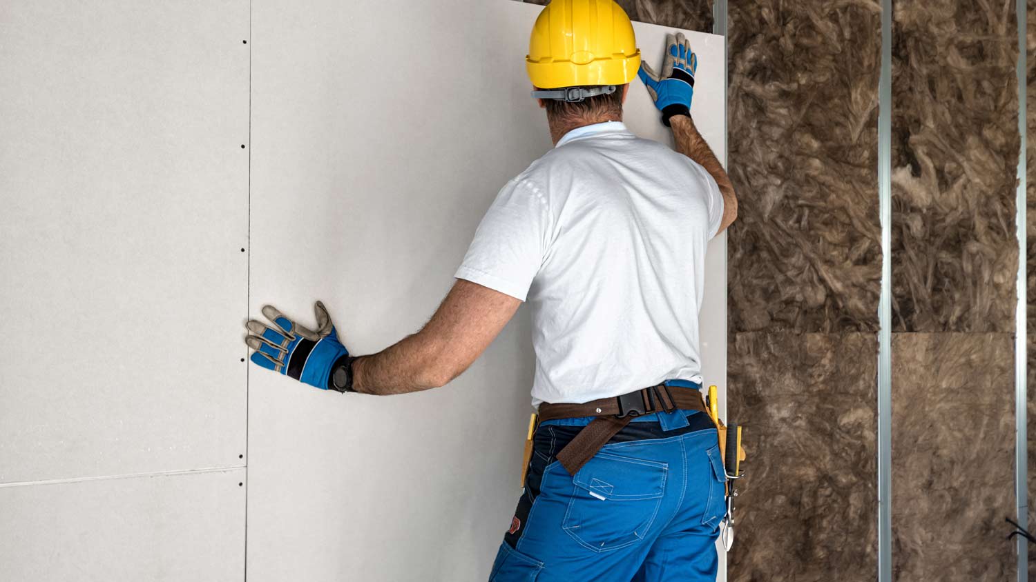 None man installing drywall