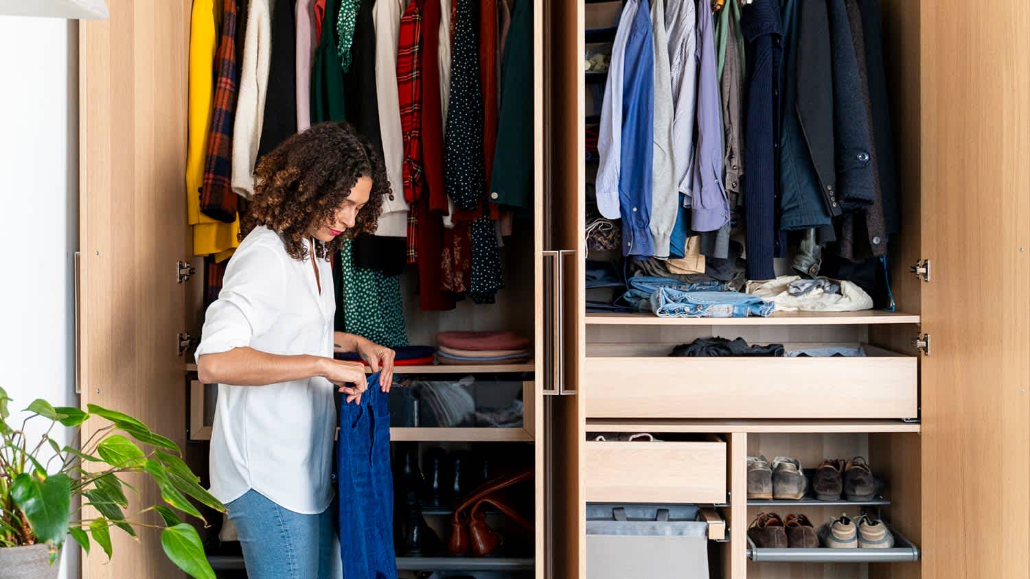 Woman clearing out her wardrobe