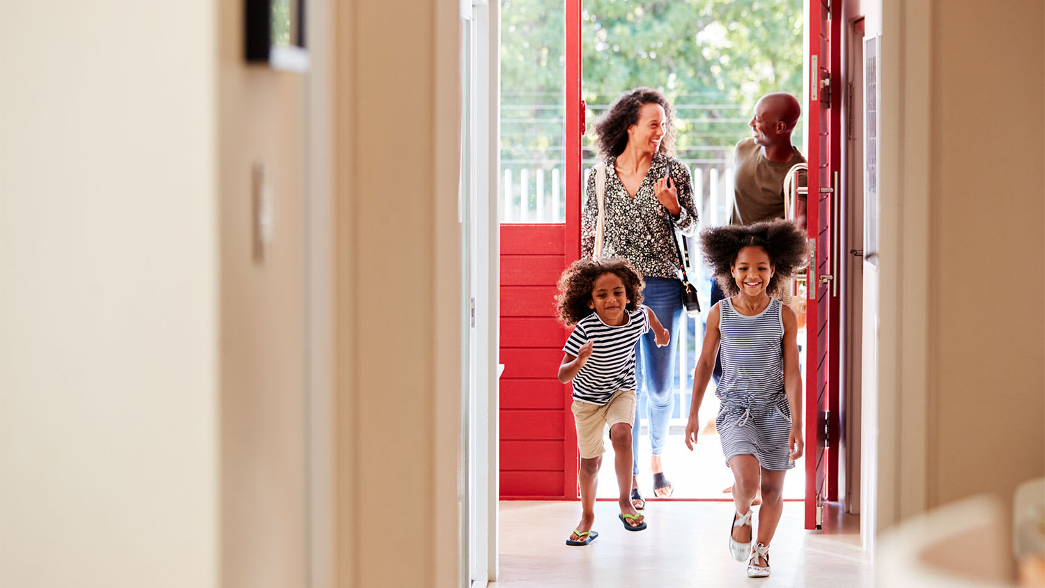 family walking through the door of their home