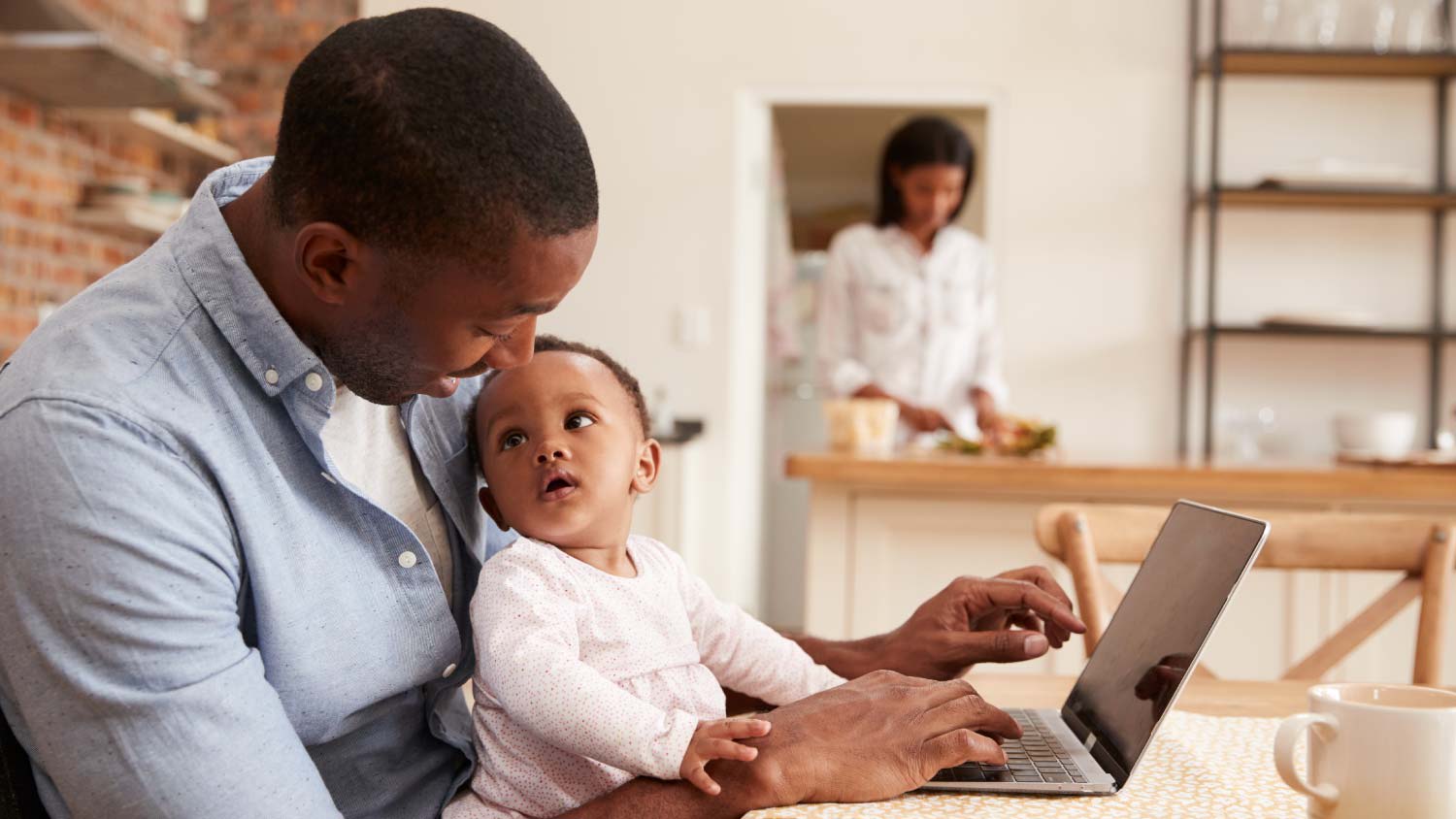 None father and child working at laptop