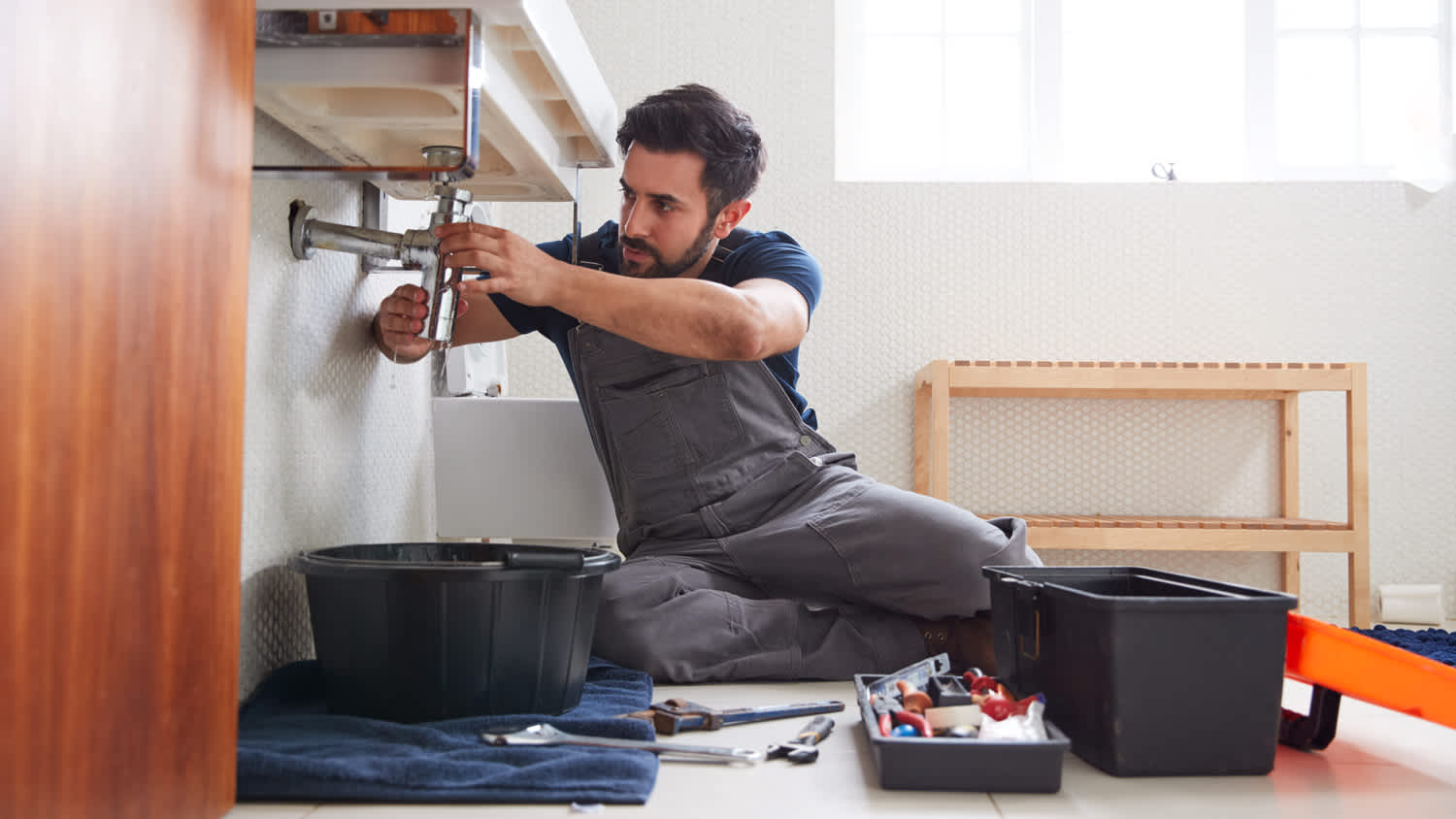Man repairing under sink.