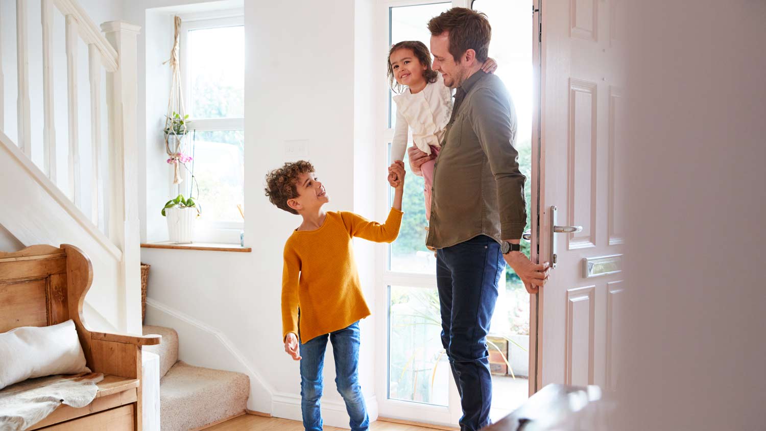 man and children enter their home