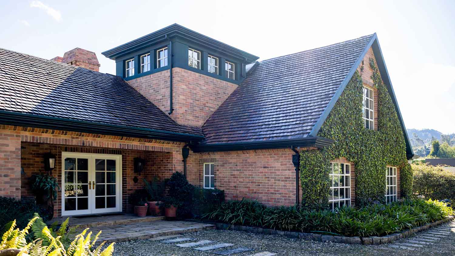 Country house with slate roof and brick siding
