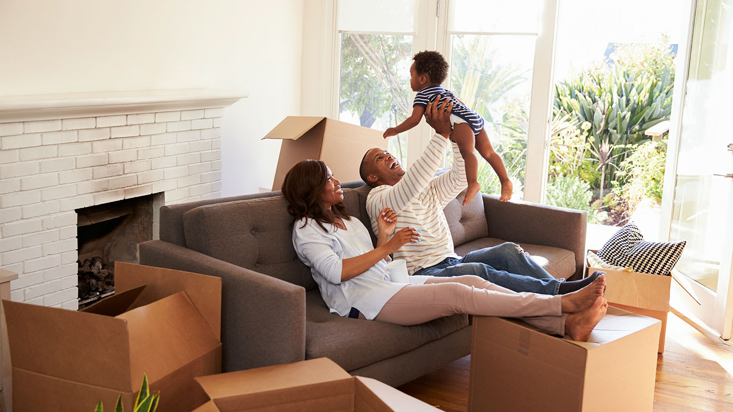 A happy family in a house with moving boxes