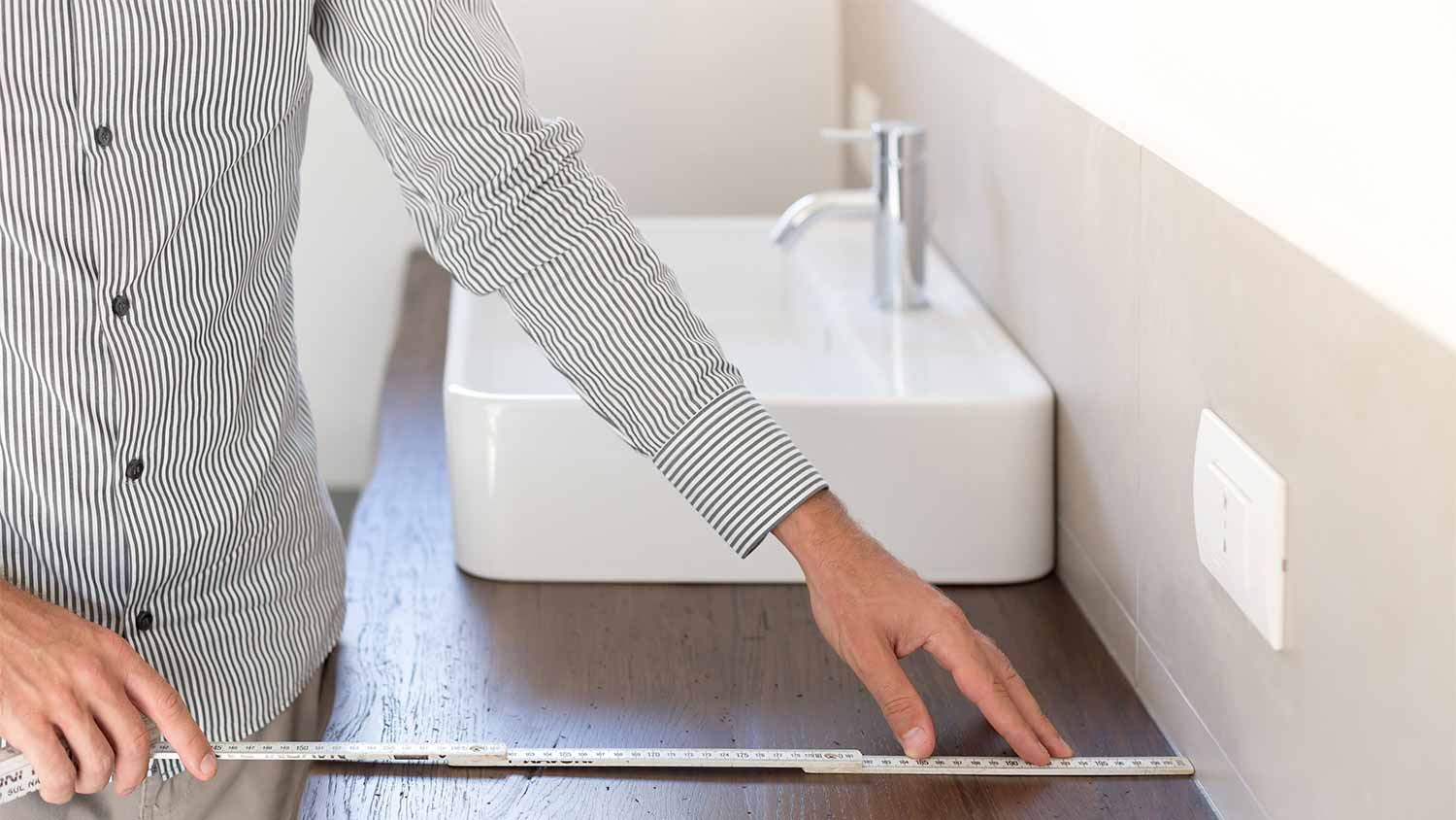 None man measuring new bathroom countertop
