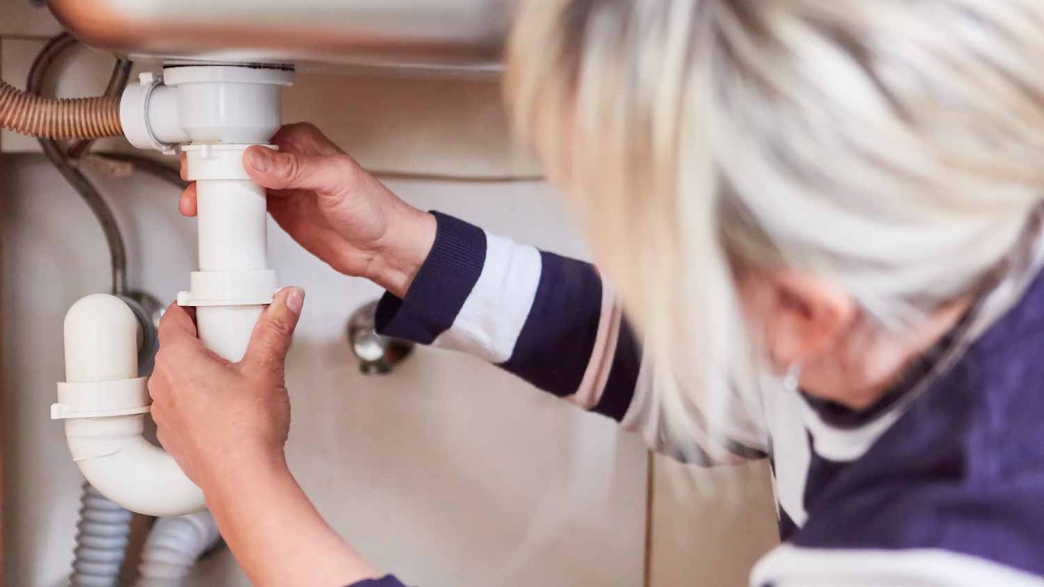 Woman checking p-trap