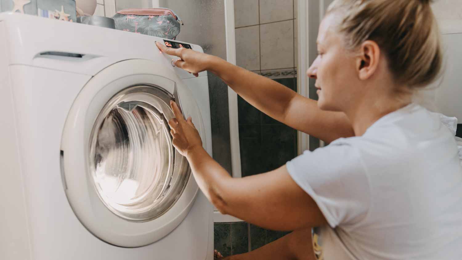 None Woman choosing program on dryer machine