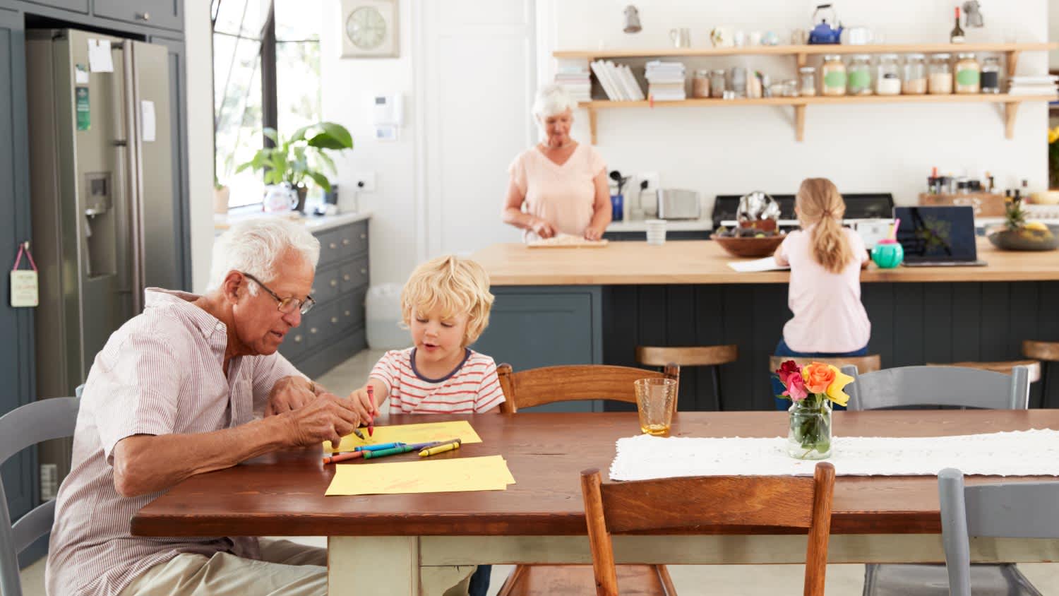 family gathered around the kitchen working