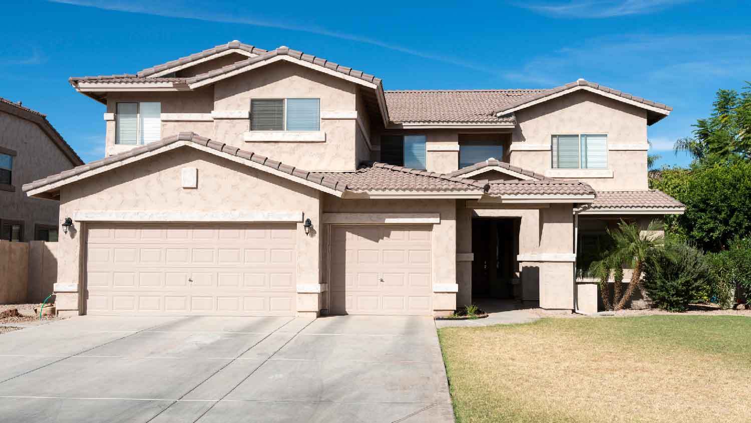 A house with a garage and a concrete driveway