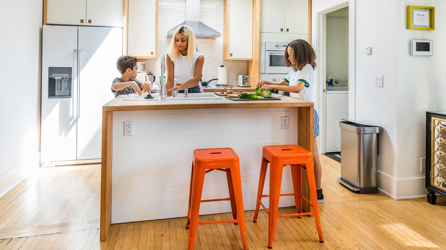 family cooking on kitchen island