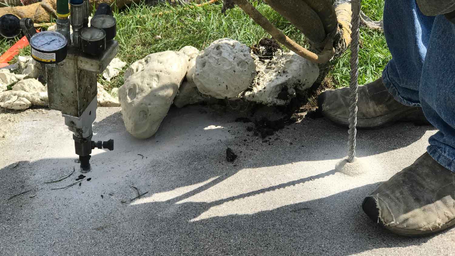 None A man polyjacking a concrete slab