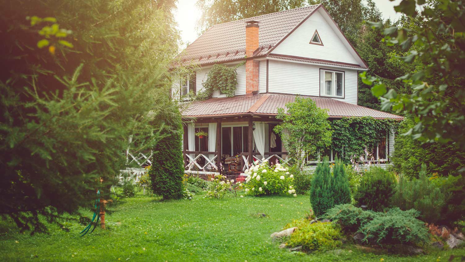 The exterior of a country house with green backyard