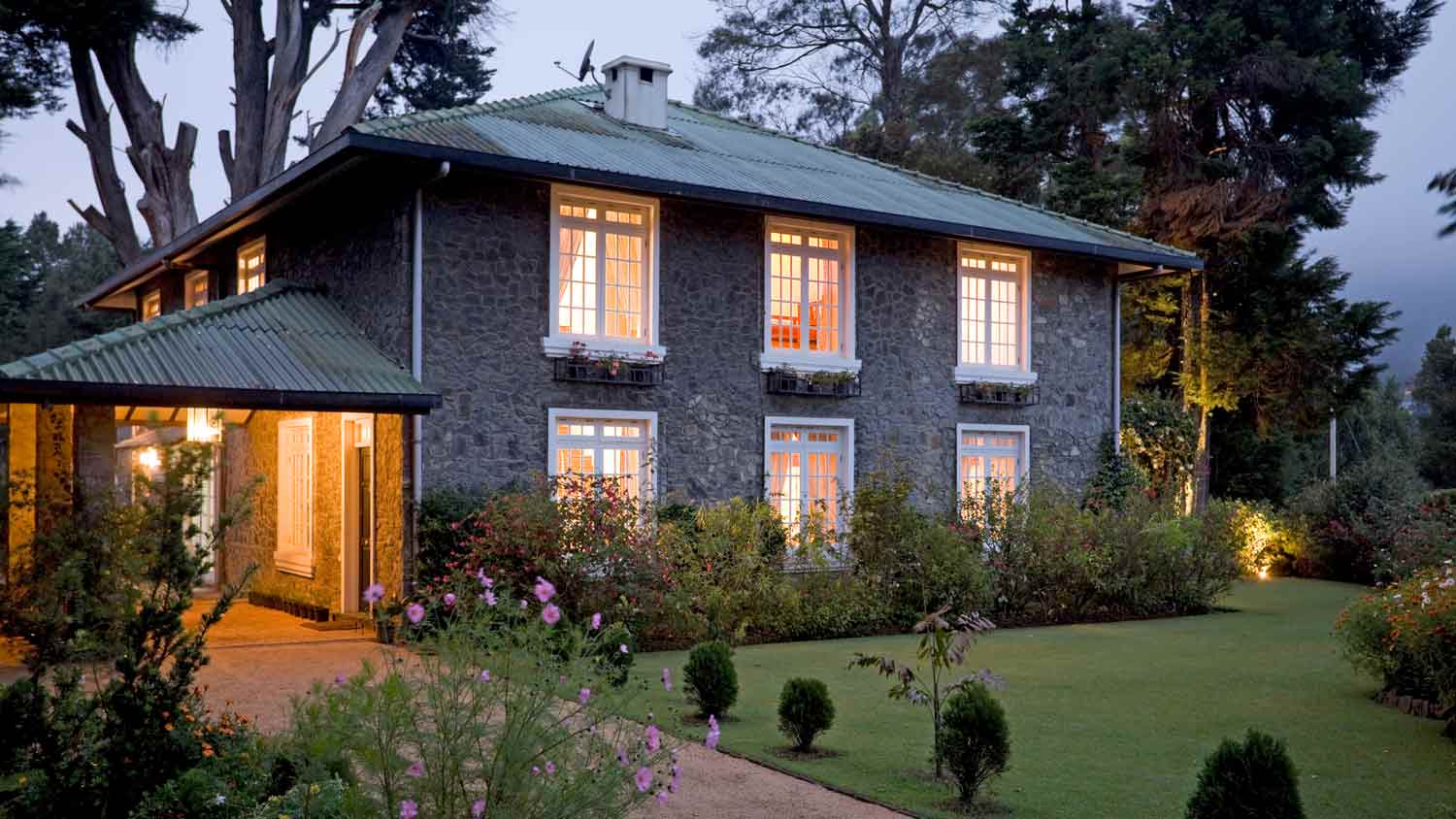 outdoor lights around large stone house