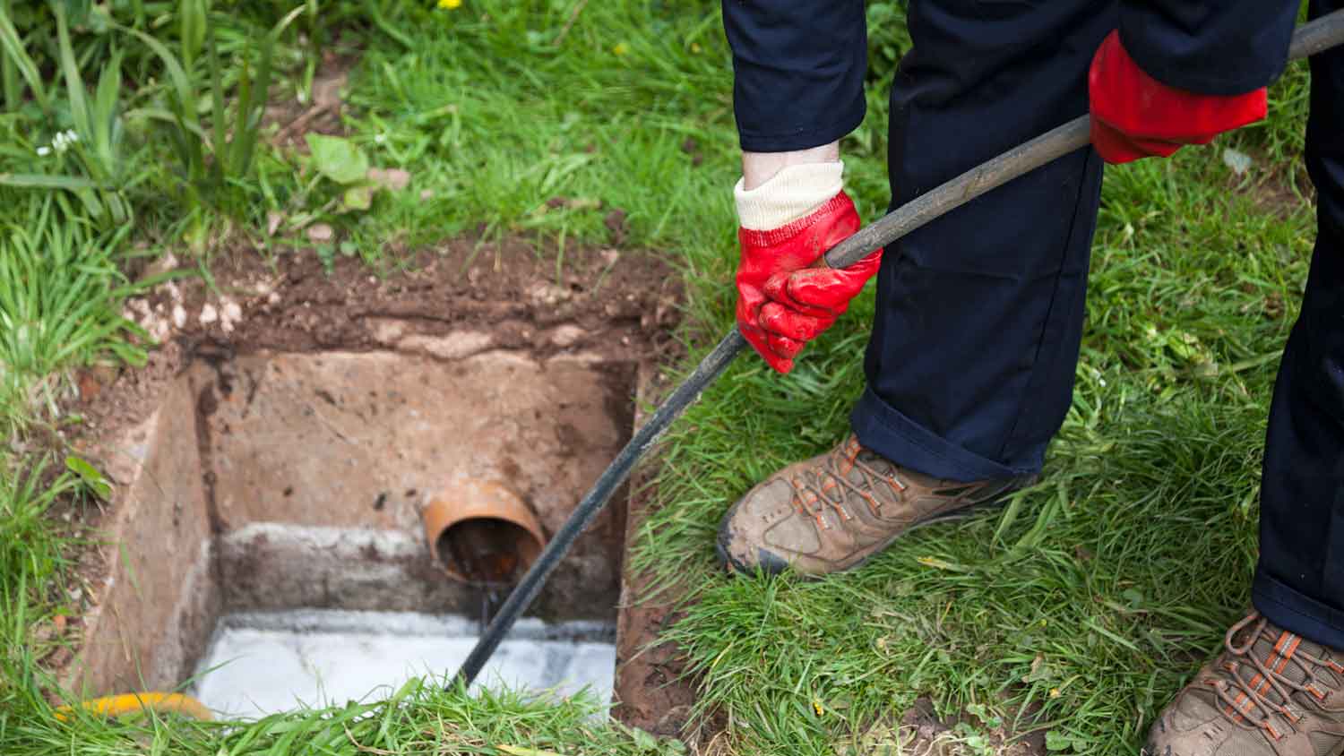 A professional unblocking a drainage