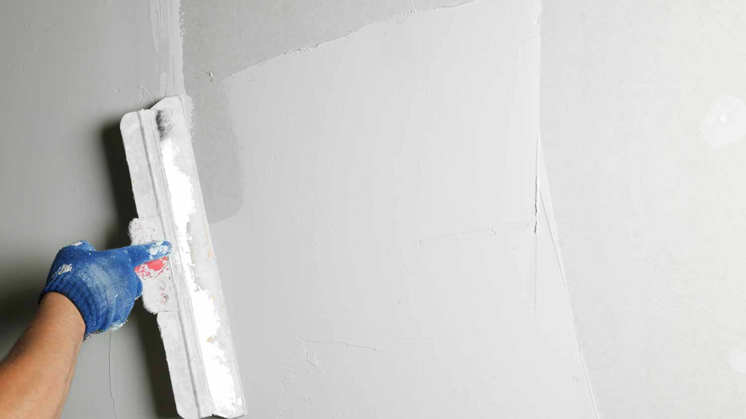 None Worker plastering wall