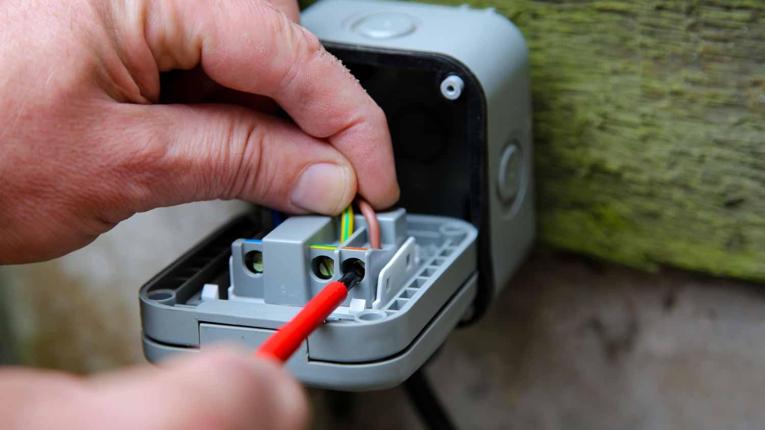 None Man wiring an electric socket