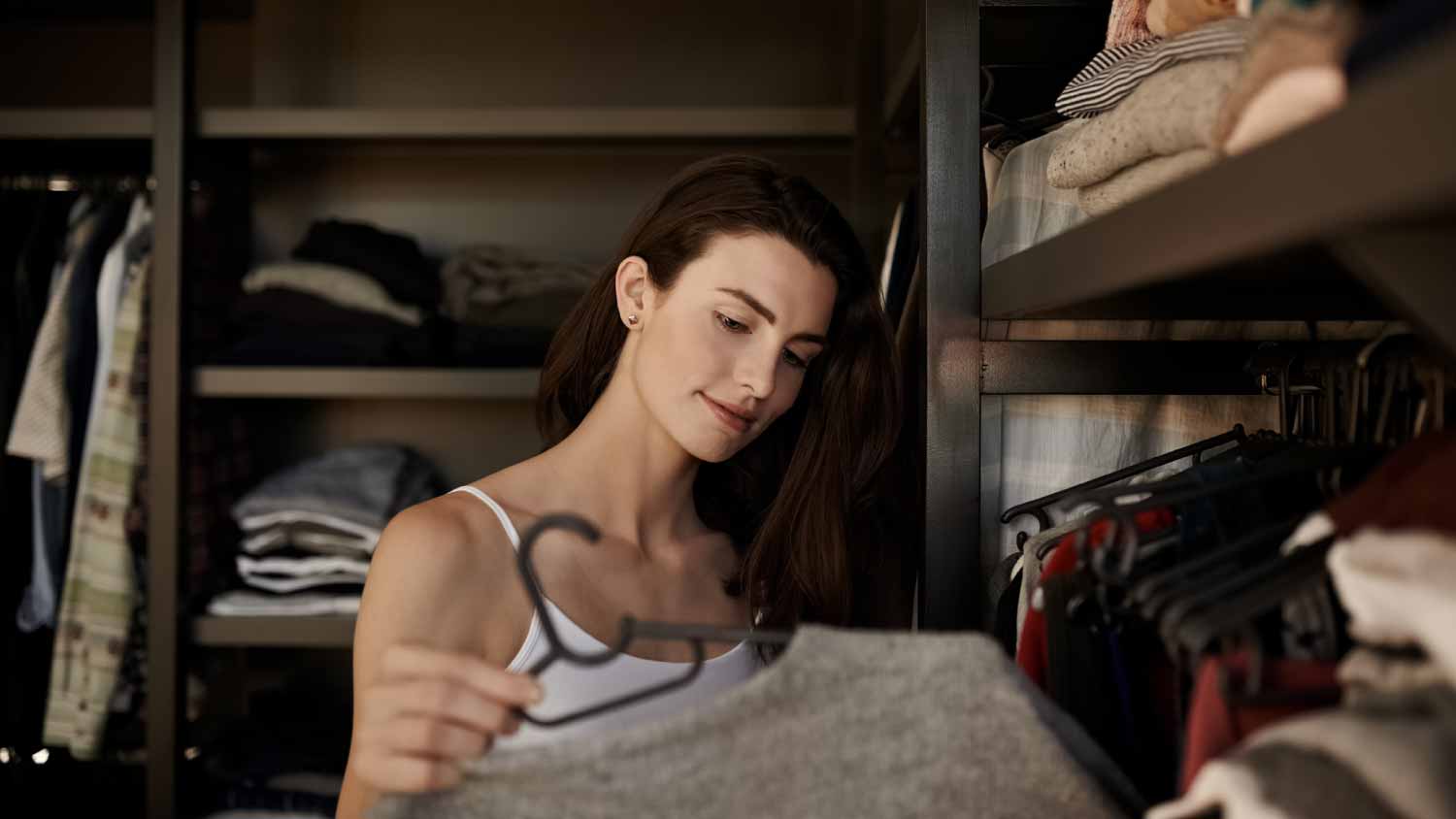 None Woman choosing clothes from her closet