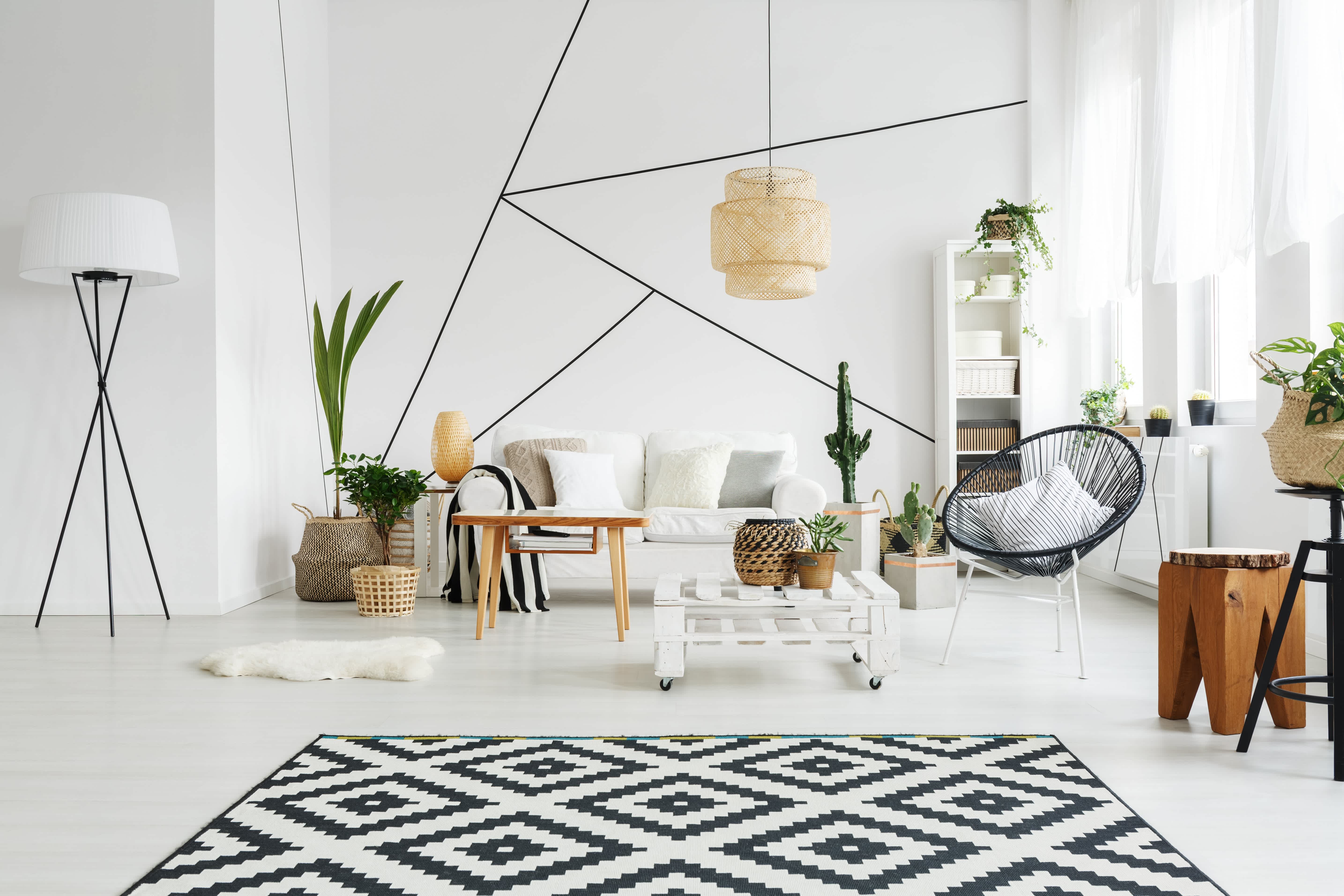 A black-and-white themed living room with a geometric accent wall