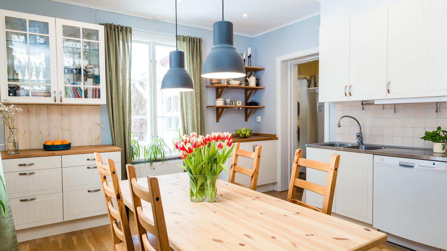 A kitchen with wooden floors and a wooden table