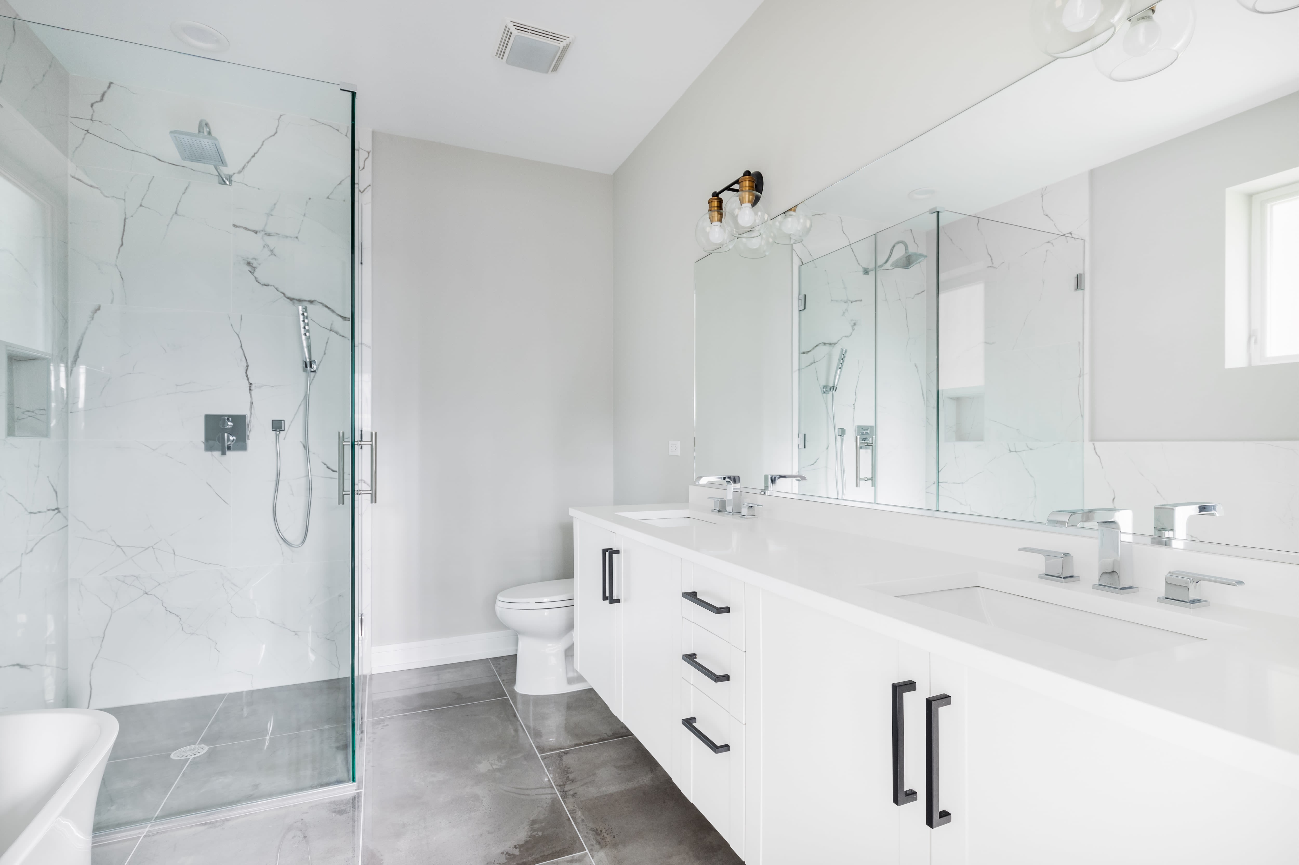Bright white modern bathroom with black hardware accents