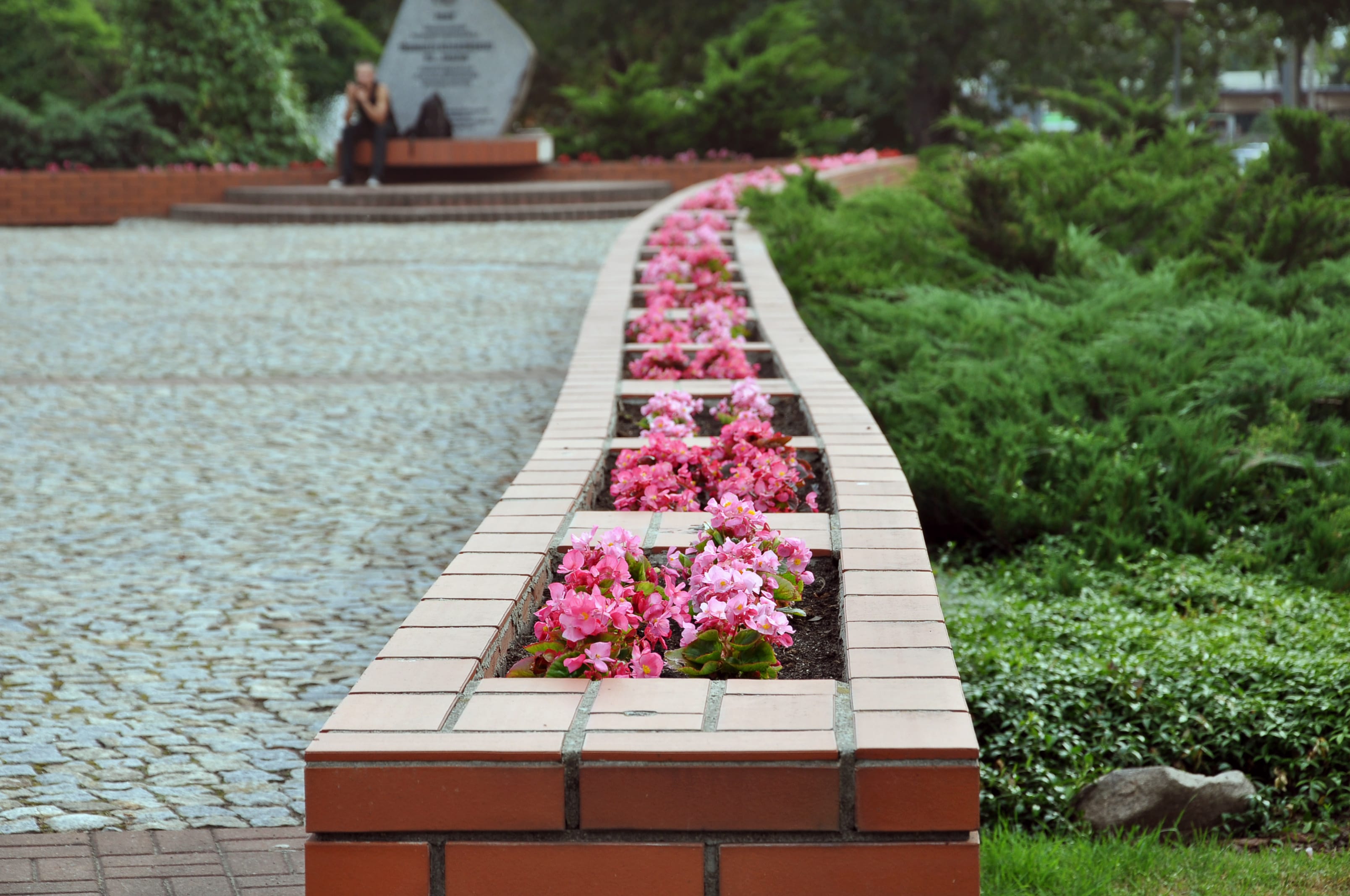 A brick retaining wall with built in flower beds