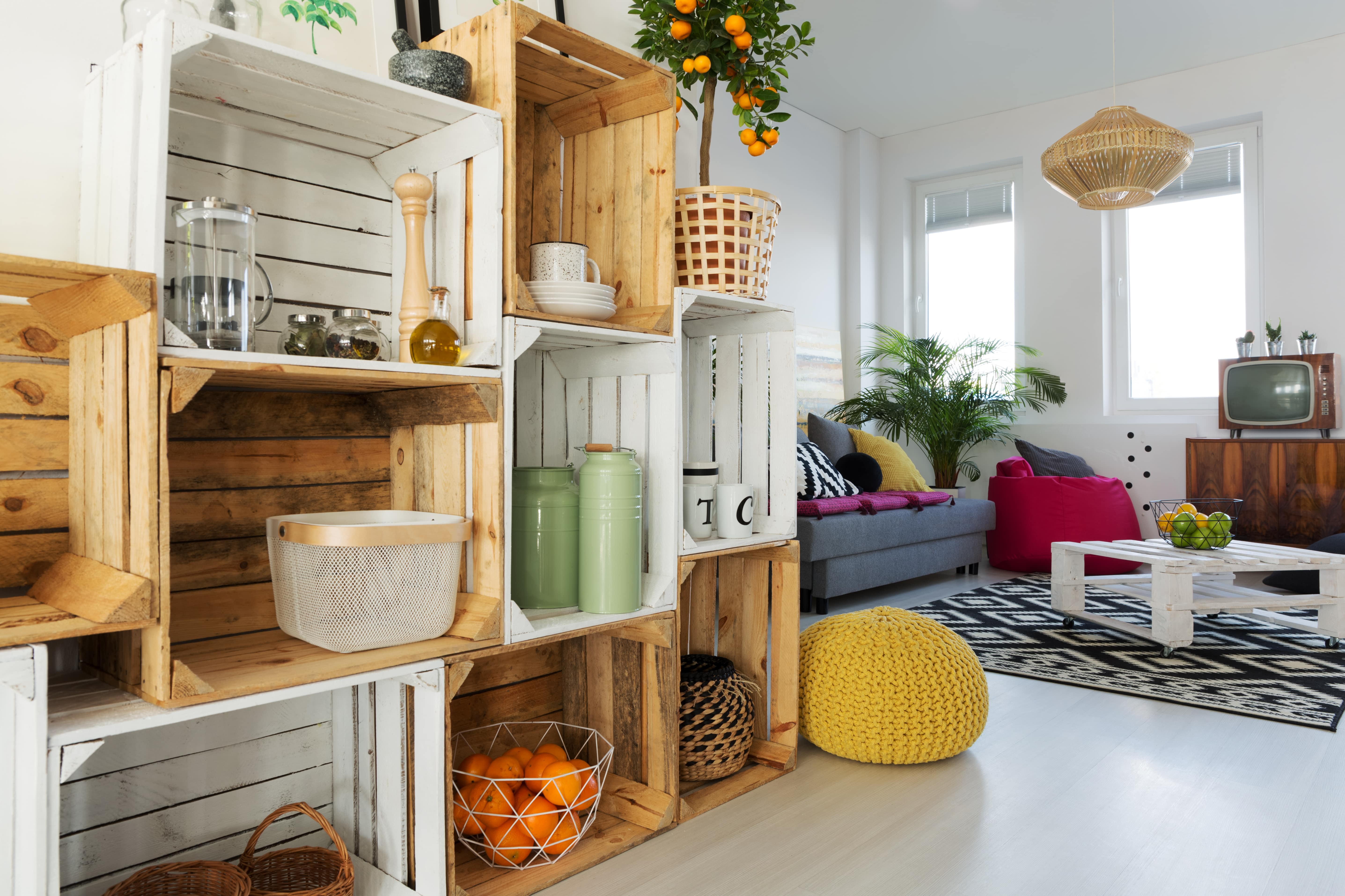 The corner of a loft apartment with repurposed crates for shelves