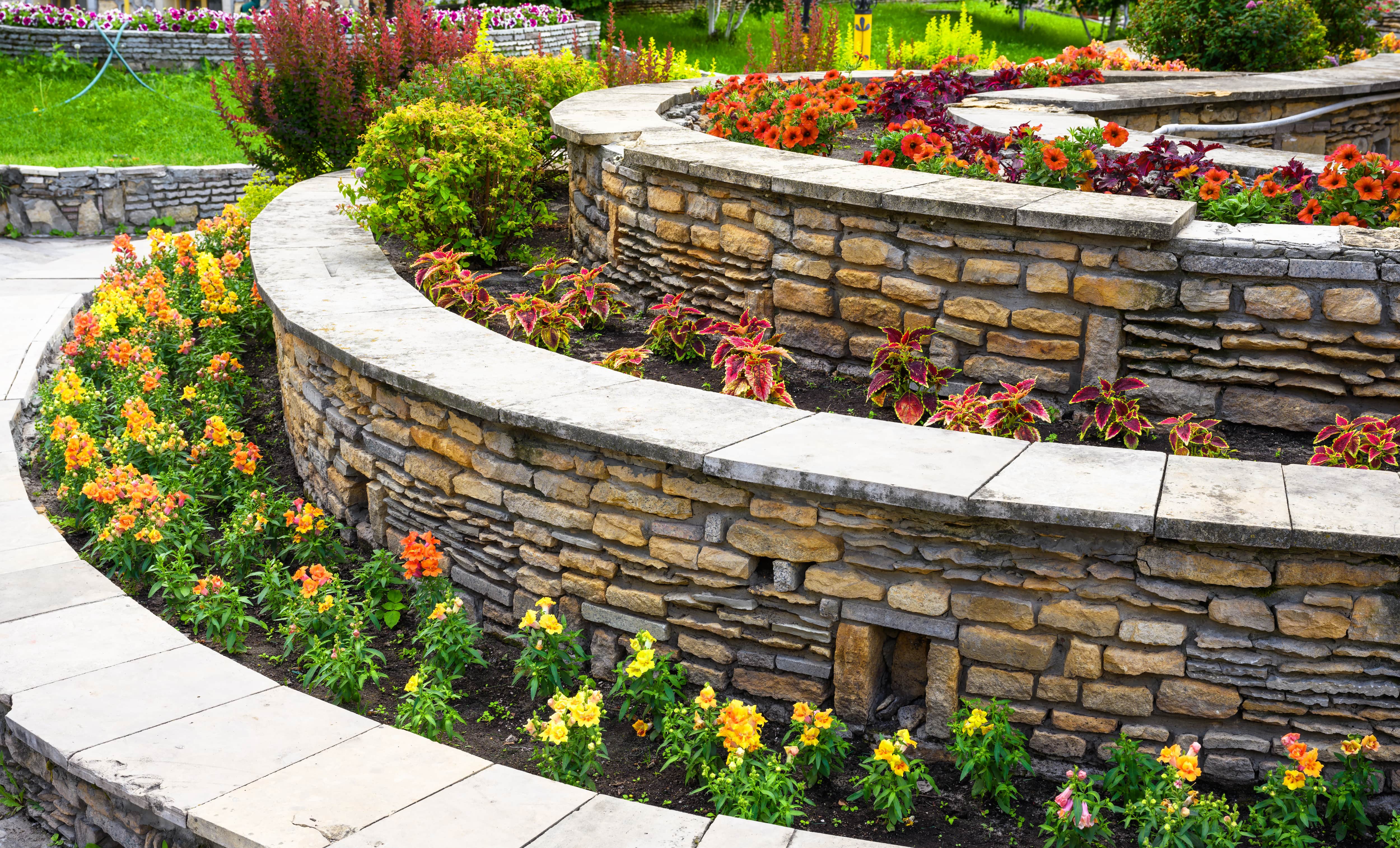 A three-tiered rationing wall surrounding plants and flowers