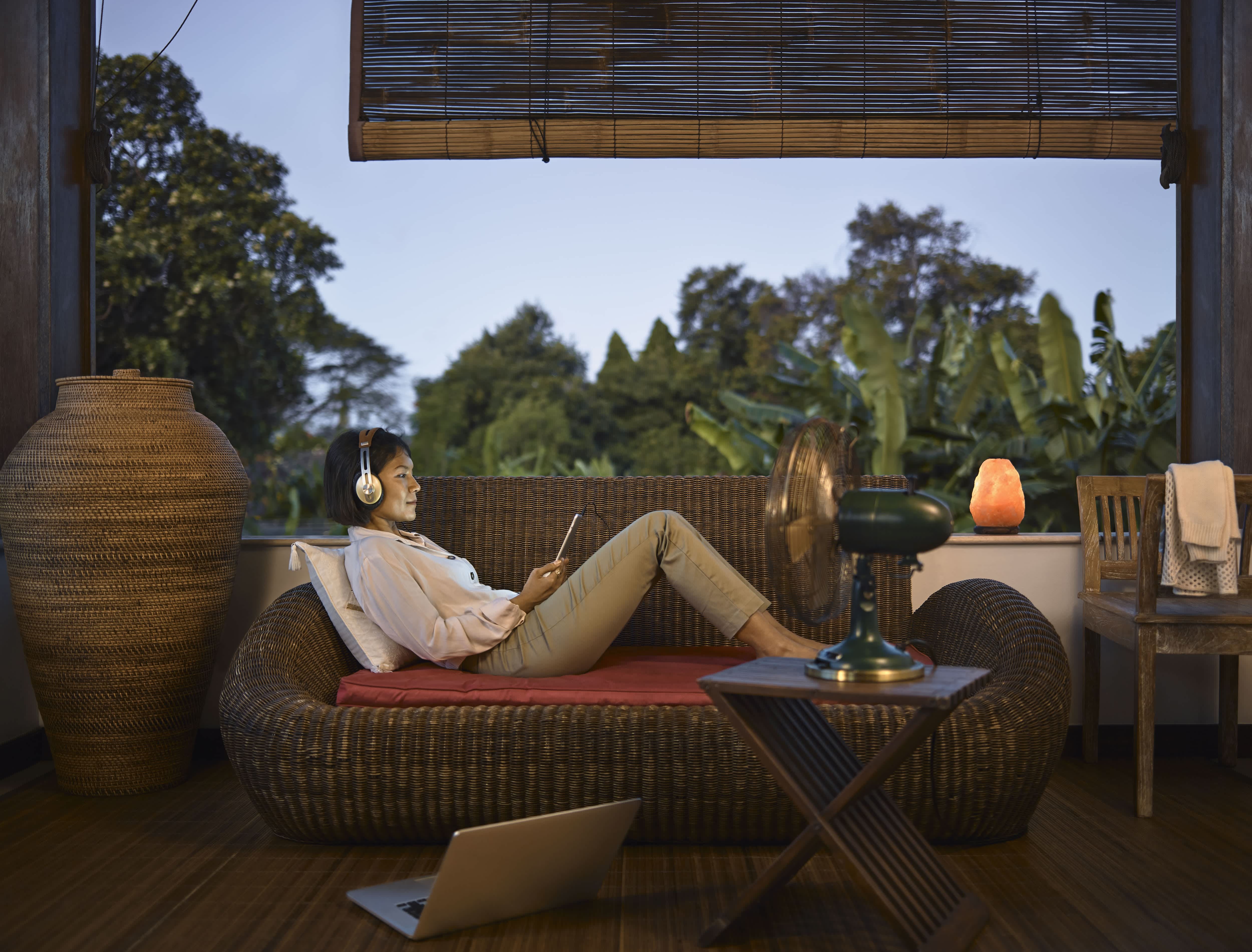 Woman working in covered porch with pull-down shade