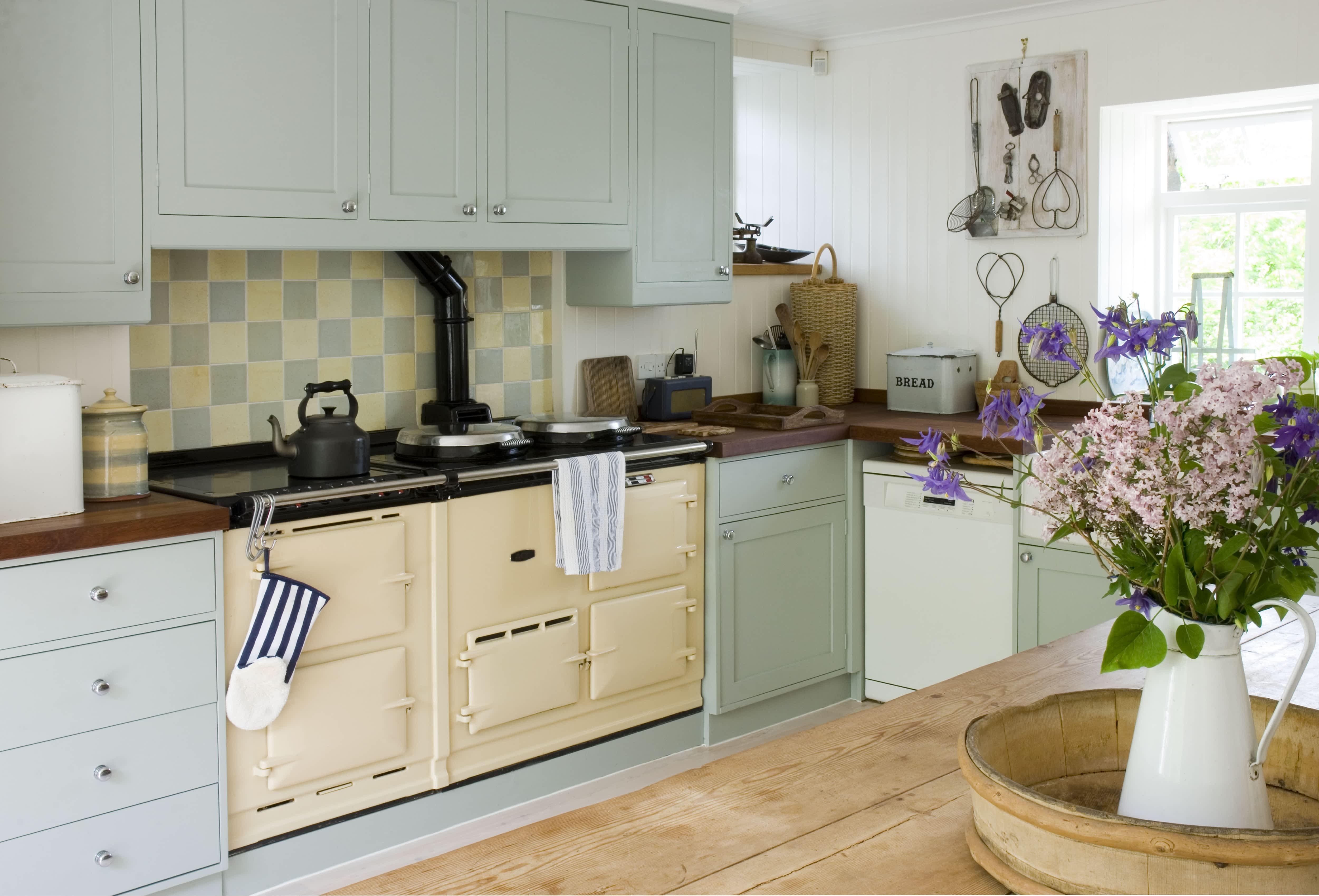 A yellow and light blue themed kitchen with checkered backsplash