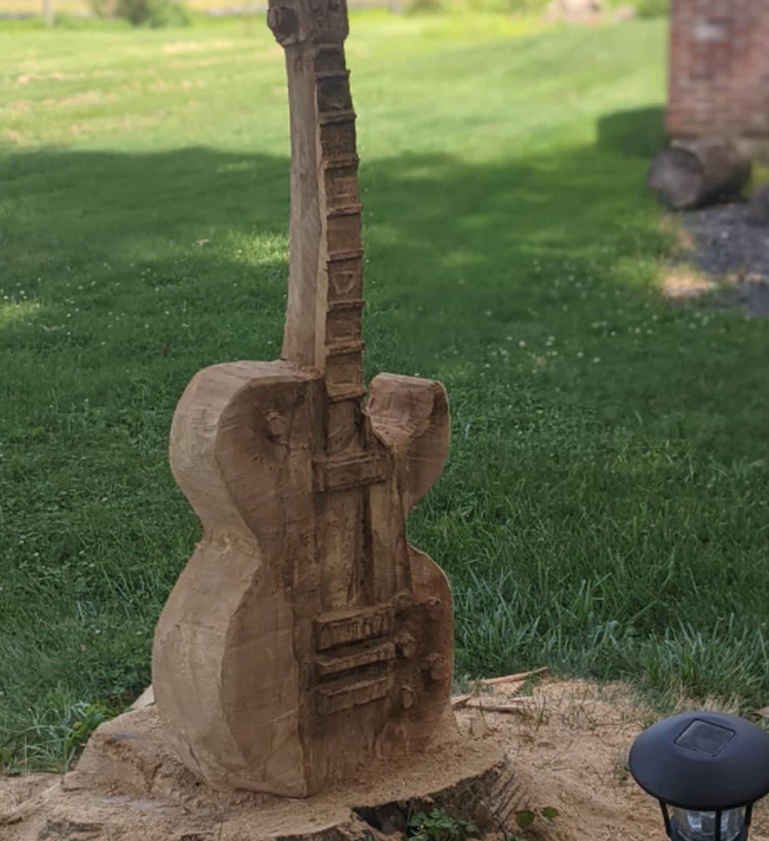 None A rustic guitar carving