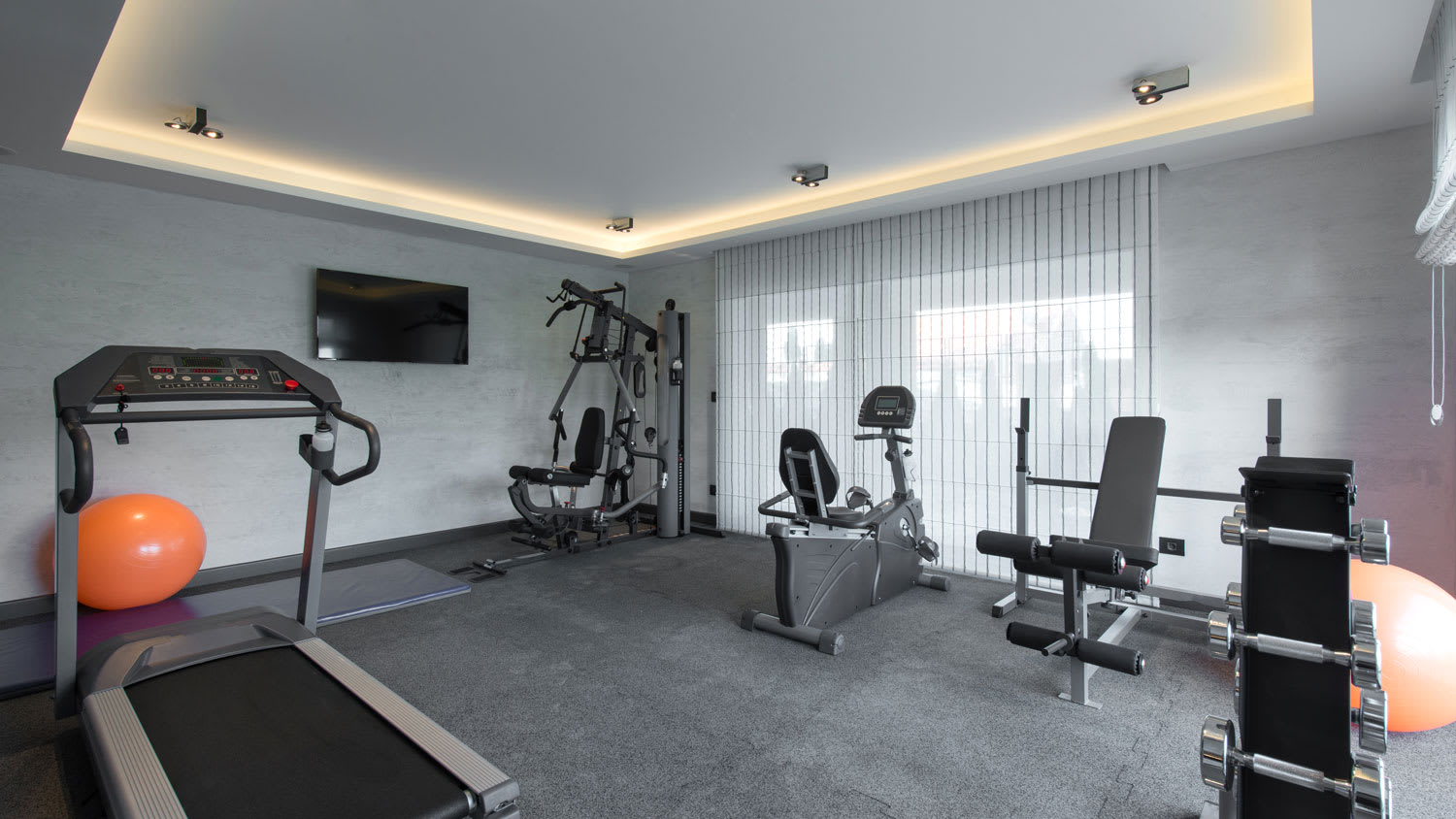 A home gym with equipment and space to stretch out