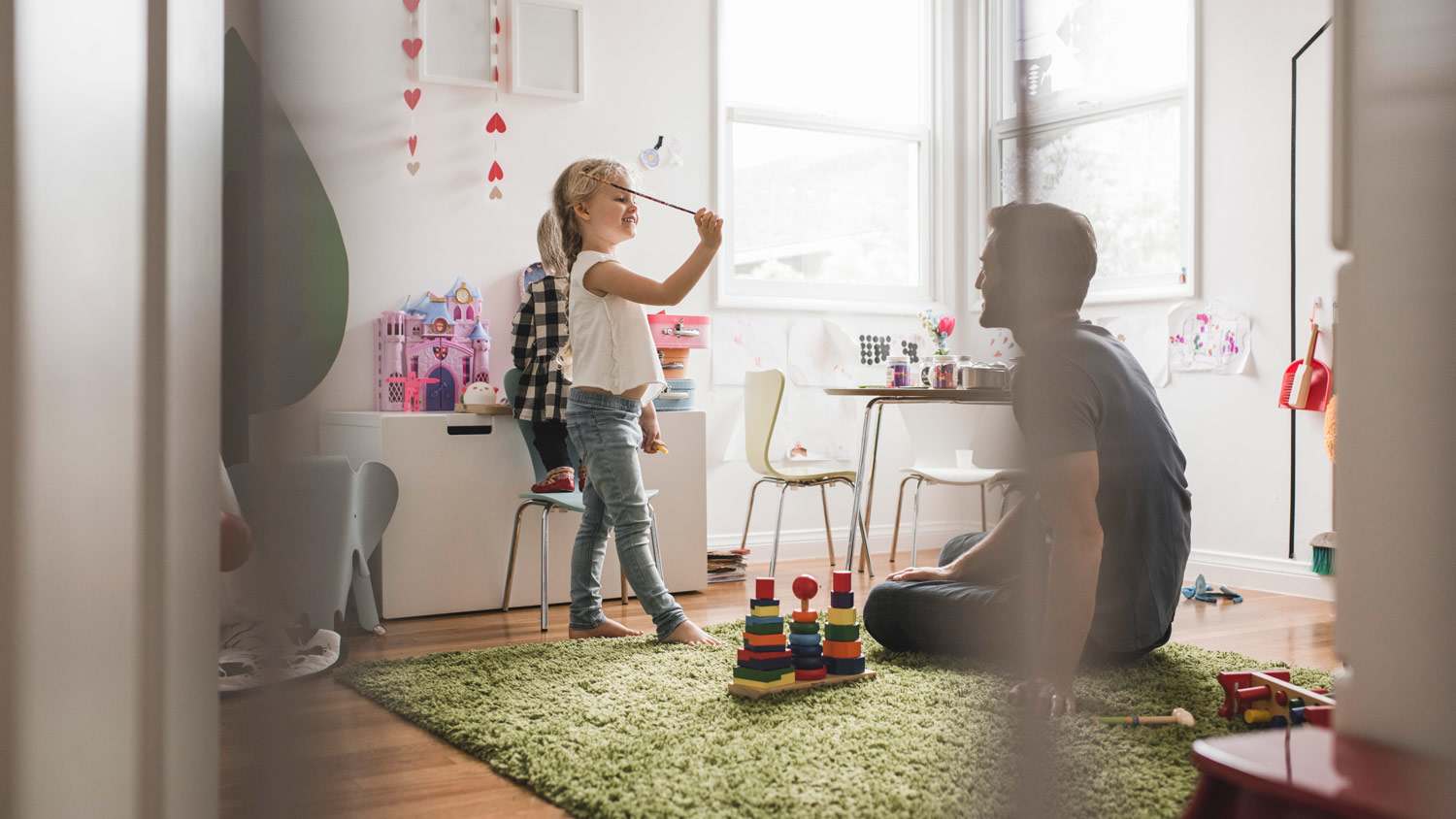 A daughter playing in the playroom with her father