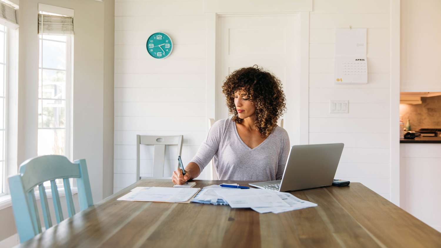 A woman organising bills and notepads