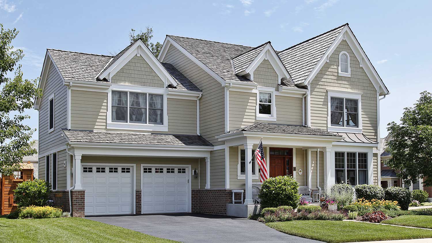 Big suburban house with light green vinyl siding