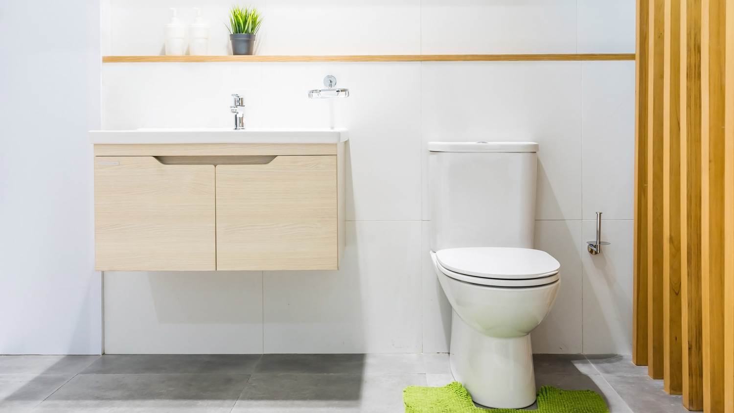 A comfort height toilet in a bright bathroom