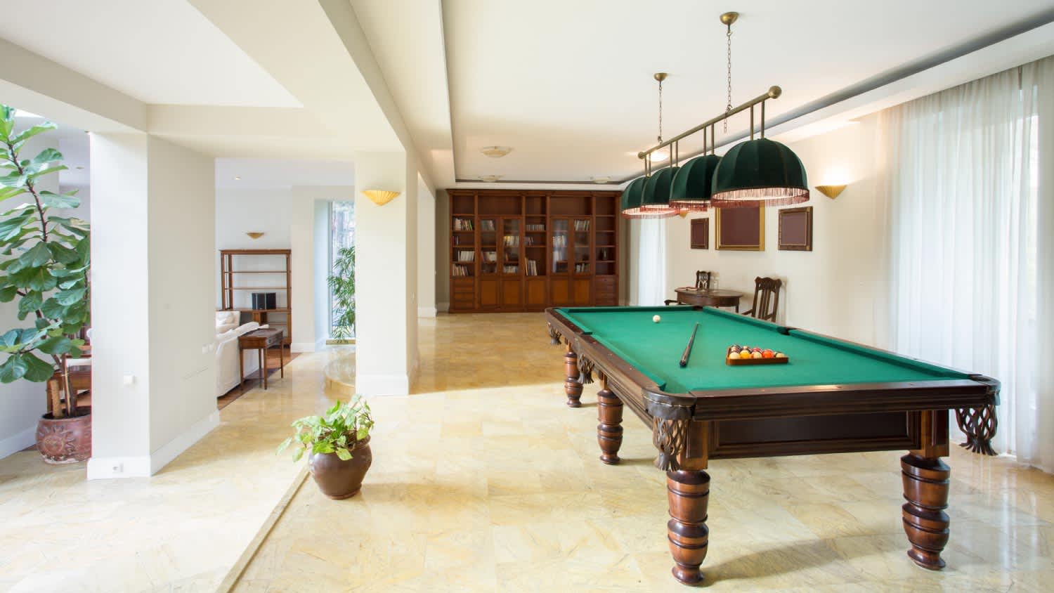 A living room with a pool table