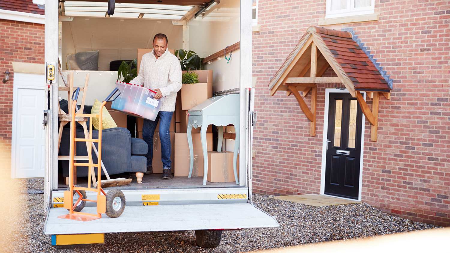 A man unloading boxes from moving truck