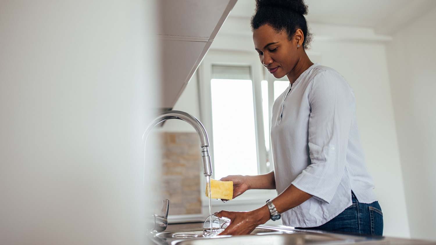 A woman doing the dishes in a kitchen