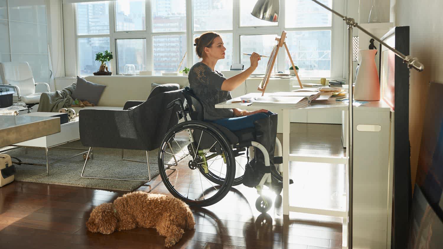 A woman painting with a brush her living room