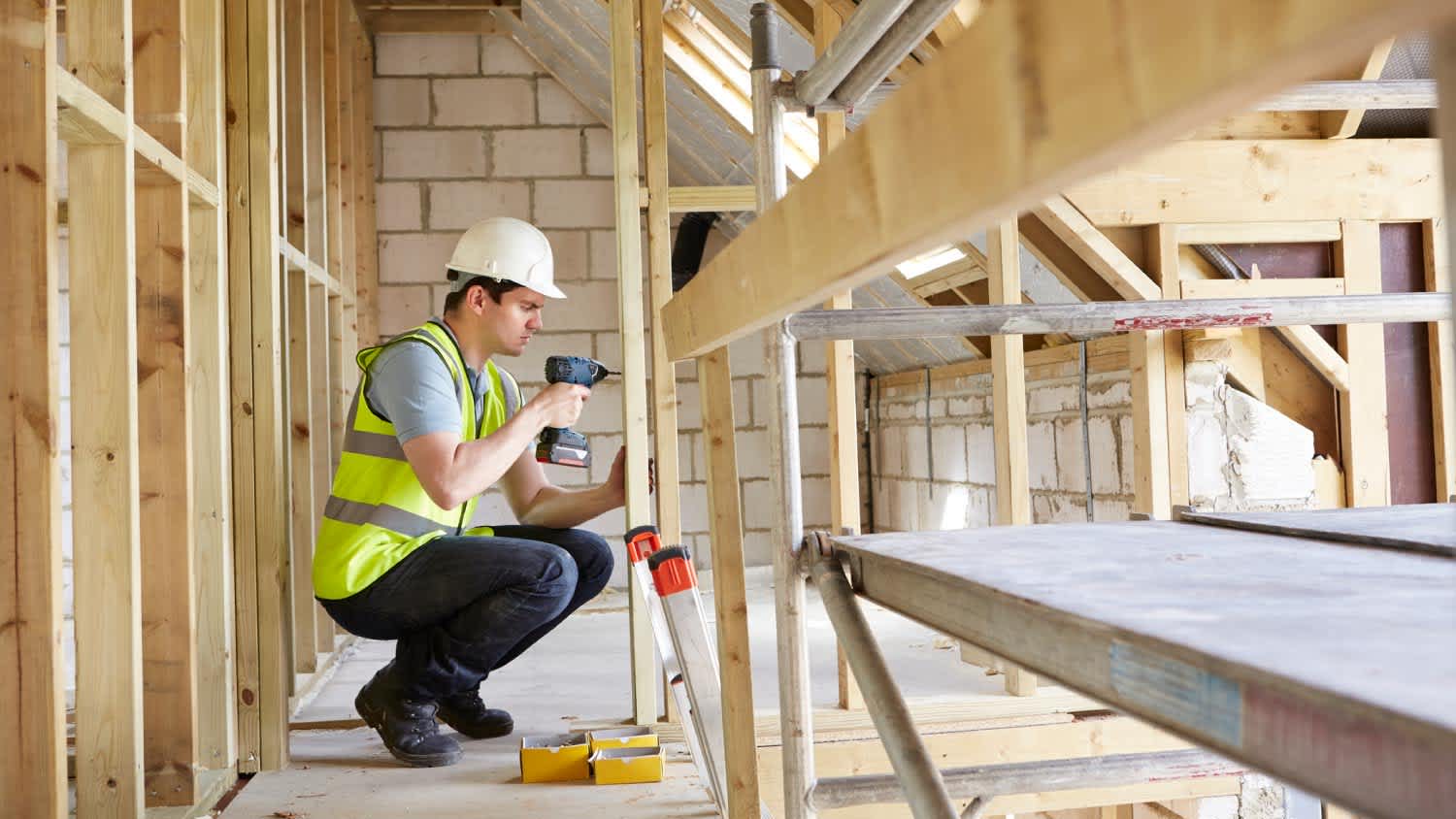 A construction worker using drill