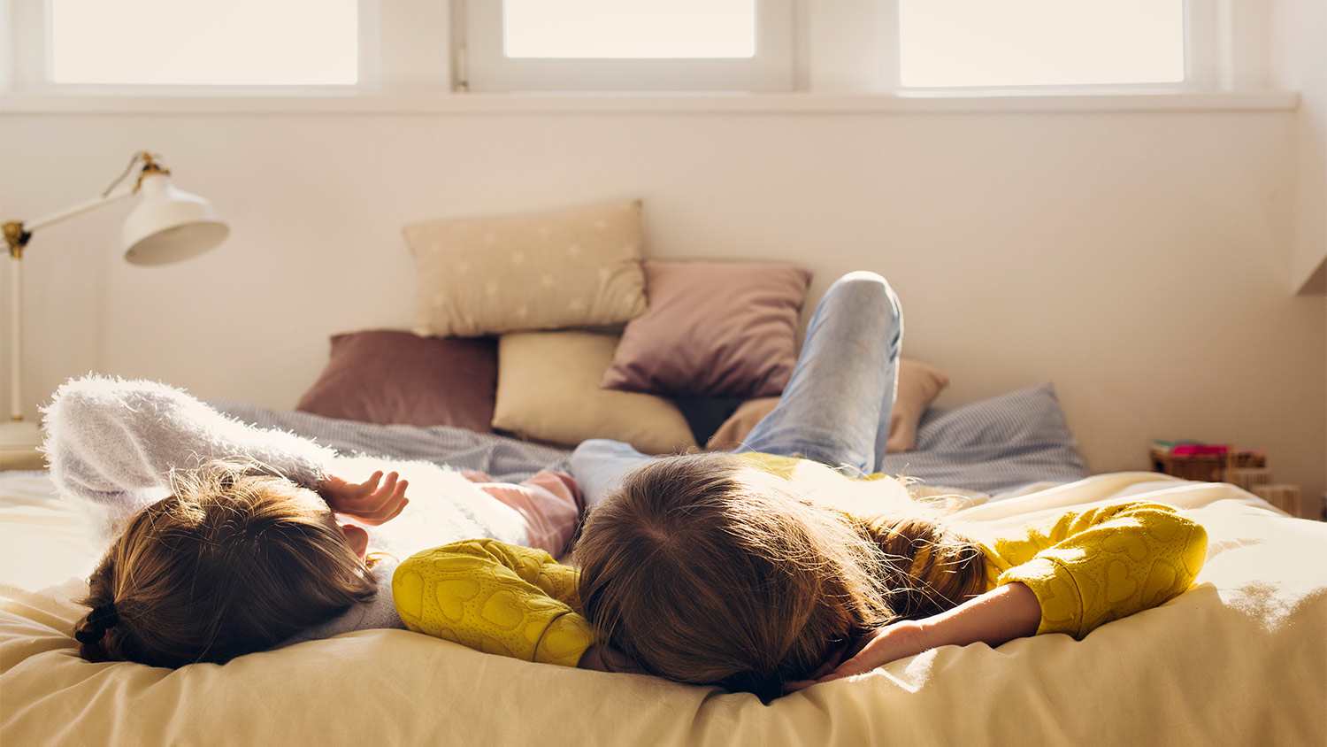 Kids on bed in sunshine