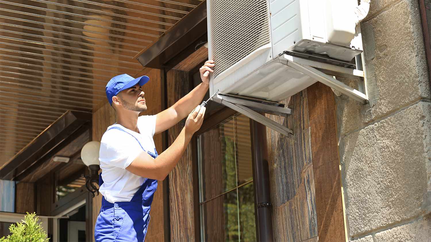 professional inspecting outdoor air conditioner