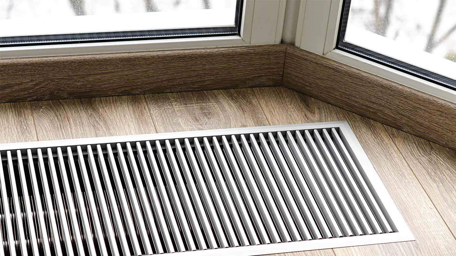 Wood floor vent near window